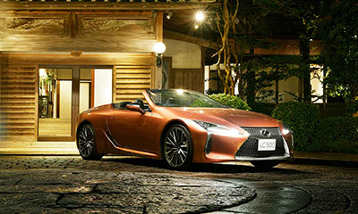 LC Convertible parked in a driveway at night.