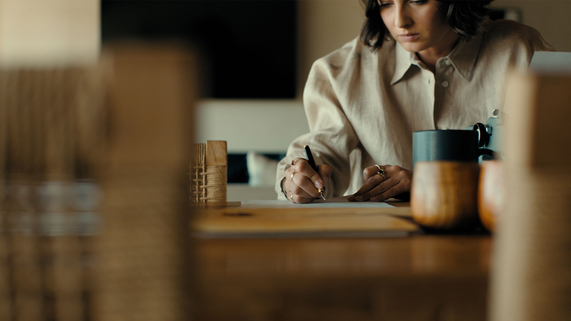 Guest signing paper work on a wooden desk