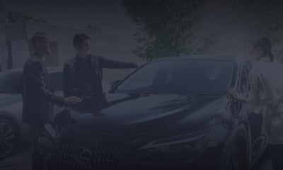 3 people gather around a black NX 250.
