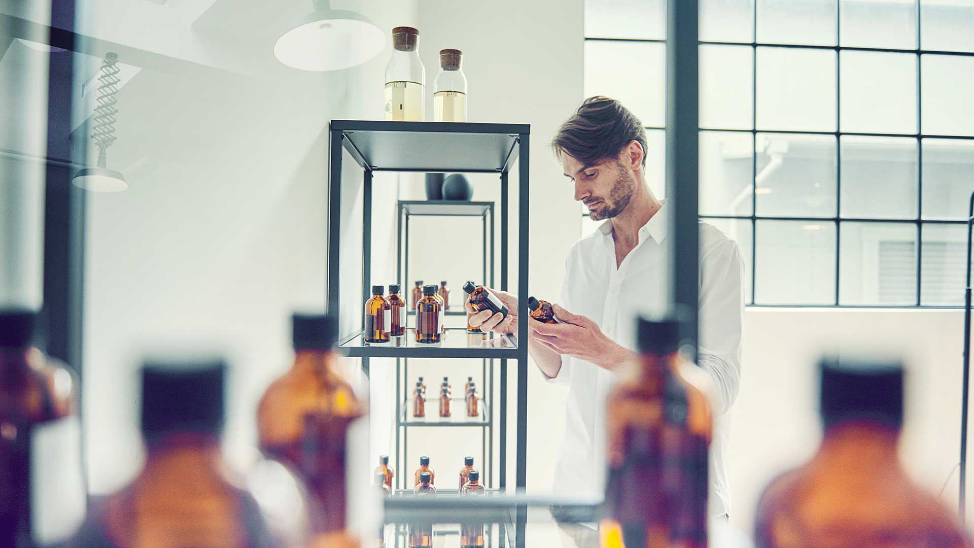 Man browsing items displayed on a glass display shelf