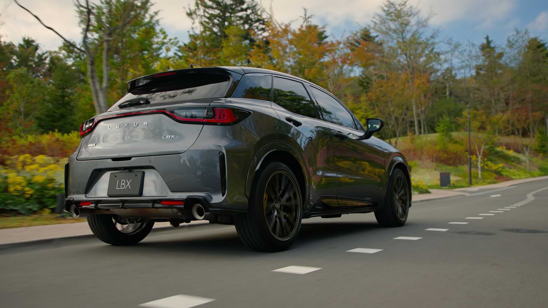Black LBX Morizo RR concept vehicle rear view driving along a road