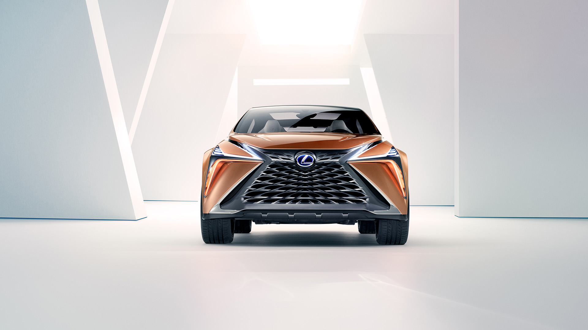Front view of a Copper Lexus LF-1 Limitless concept vehicle parked in a white room