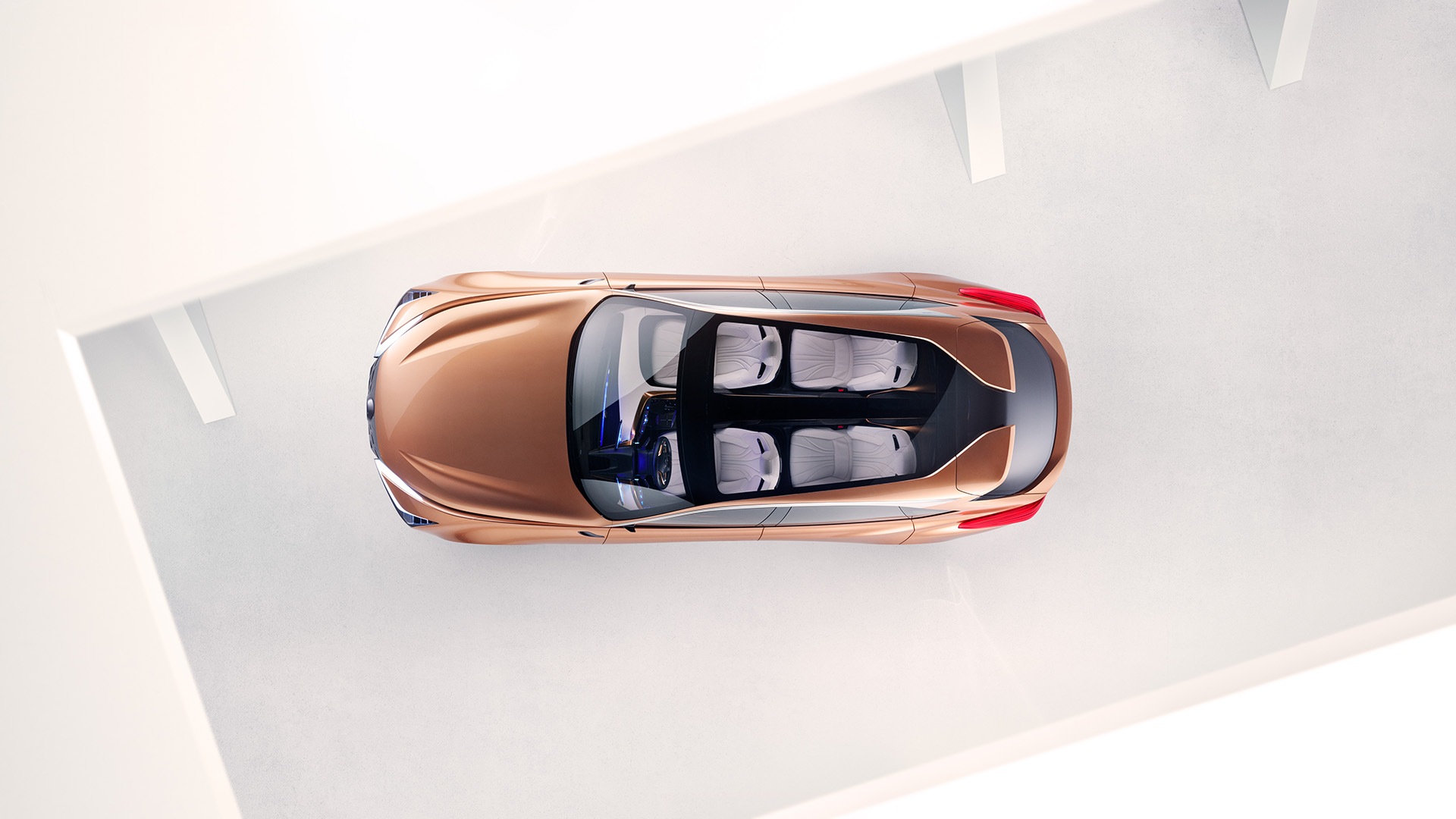 A birds-eye-view of a copper Lexus LF-1 Limitless concept vehicle parked in a white room