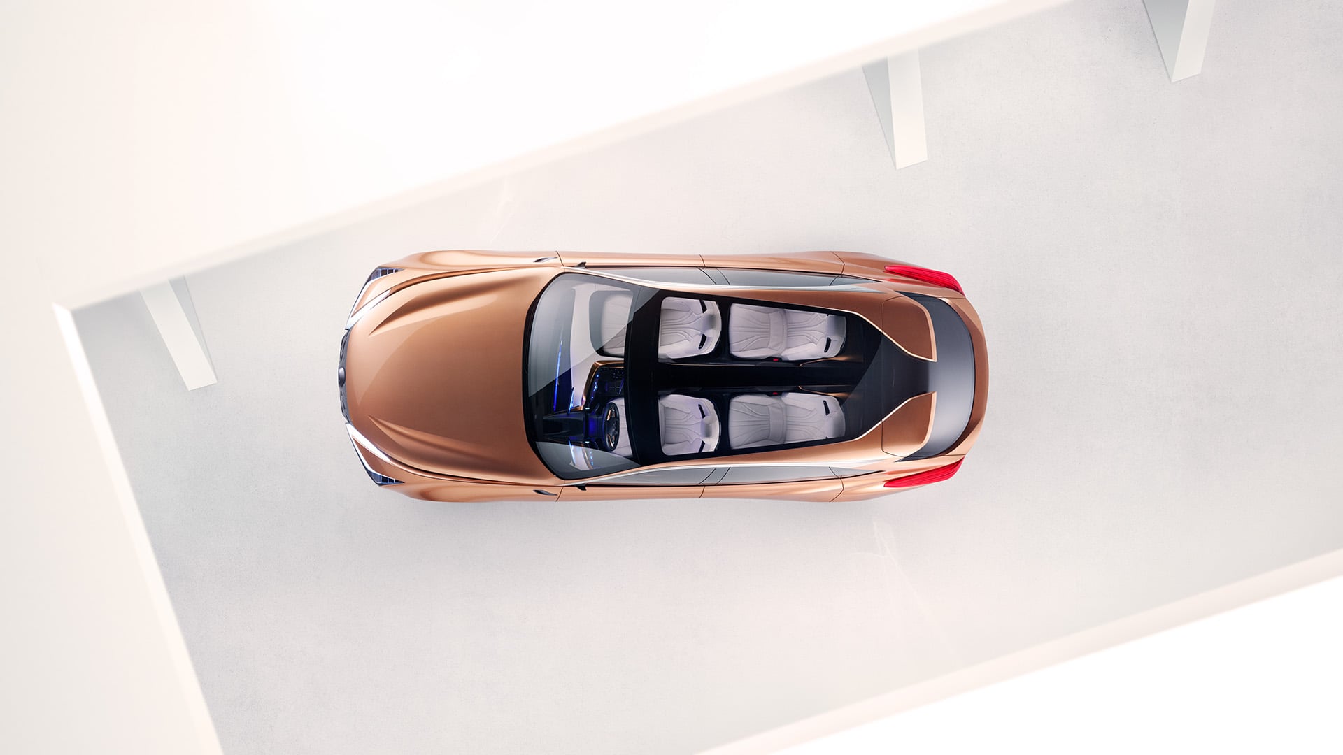 A birds-eye-view of a copper Lexus LF-1 Limitless concept vehicle parked in a white room