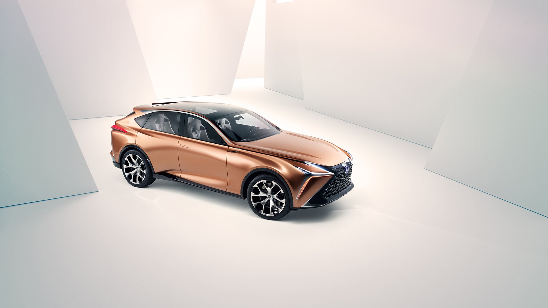 Copper Lexus LF-1 Limitless concept vehicle parked in a white room