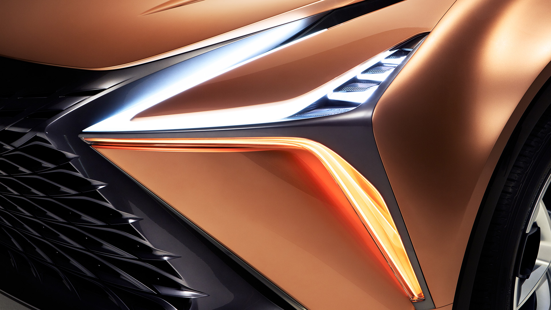 A close-up detail of a copper Lexus LF-1 Limitless concept vehicle head light