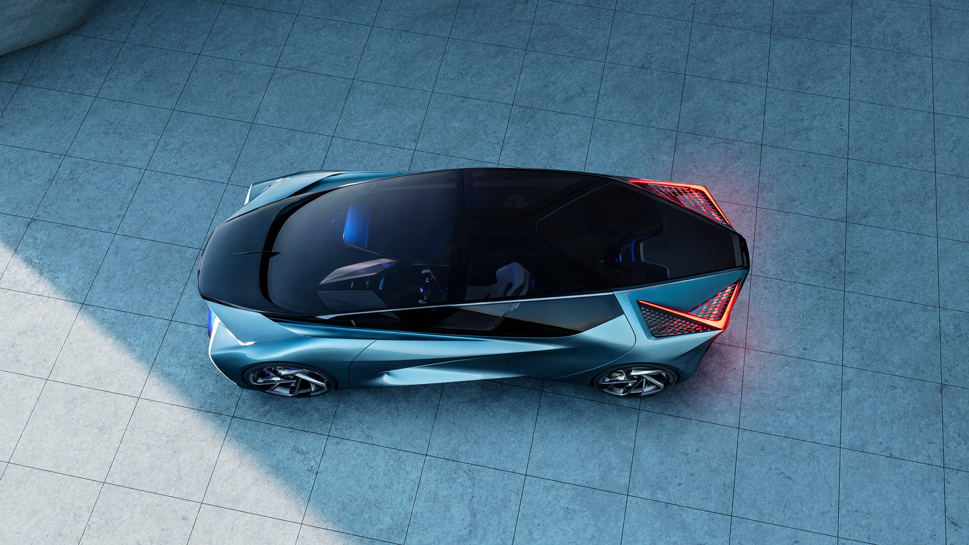Lexus LF-30 Electrified Concept vehicle in blue parked on a shaded tile ground with the tail lights on