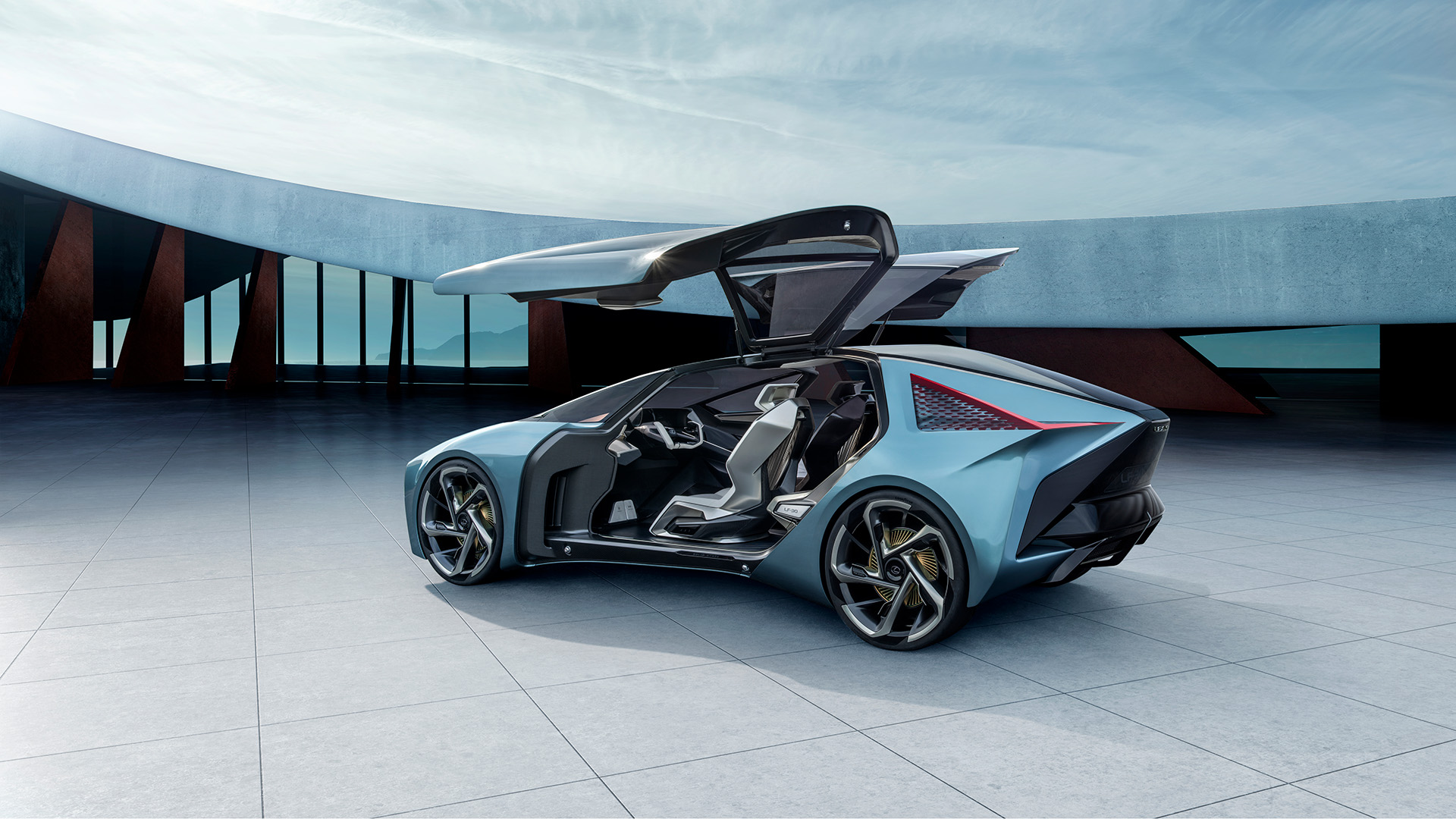 Lexus LF-30 Electrified Concept vehicle in blue parked in front of an architectural building with the passenger doors open