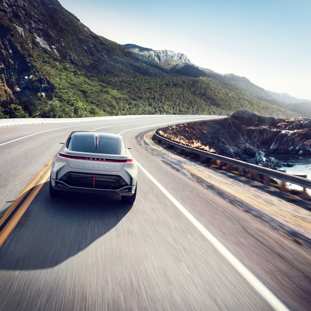White Lexus Concept Vehicle driving alone a coastal road