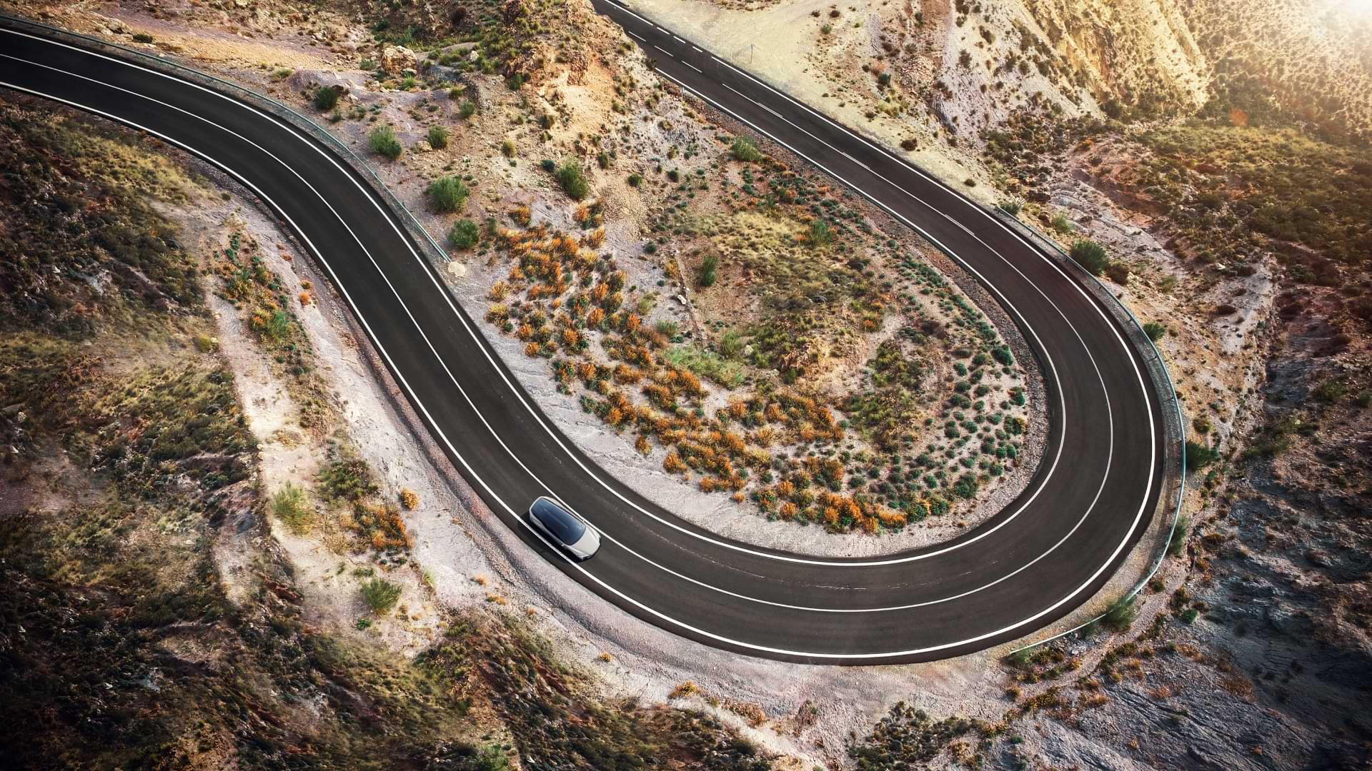 A birds eye view of a Lexus concept vehicle driving along a winding road