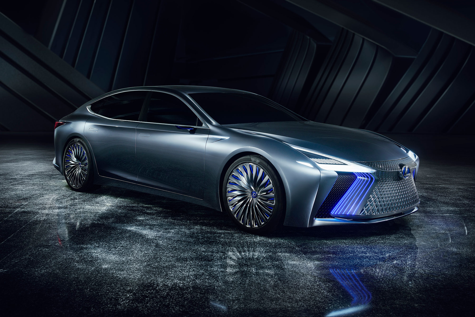 Profile view of the Lexus LS+ concept vehicle in studio setting, with blue and white lights on