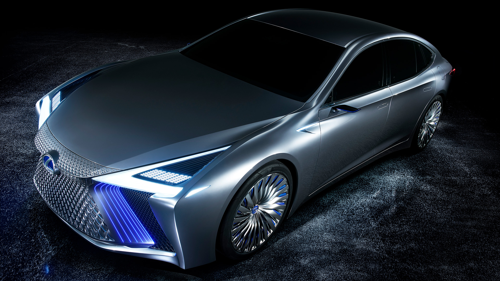Lexus LS+ concept vehicle in a studio setting with lights on, front side view 