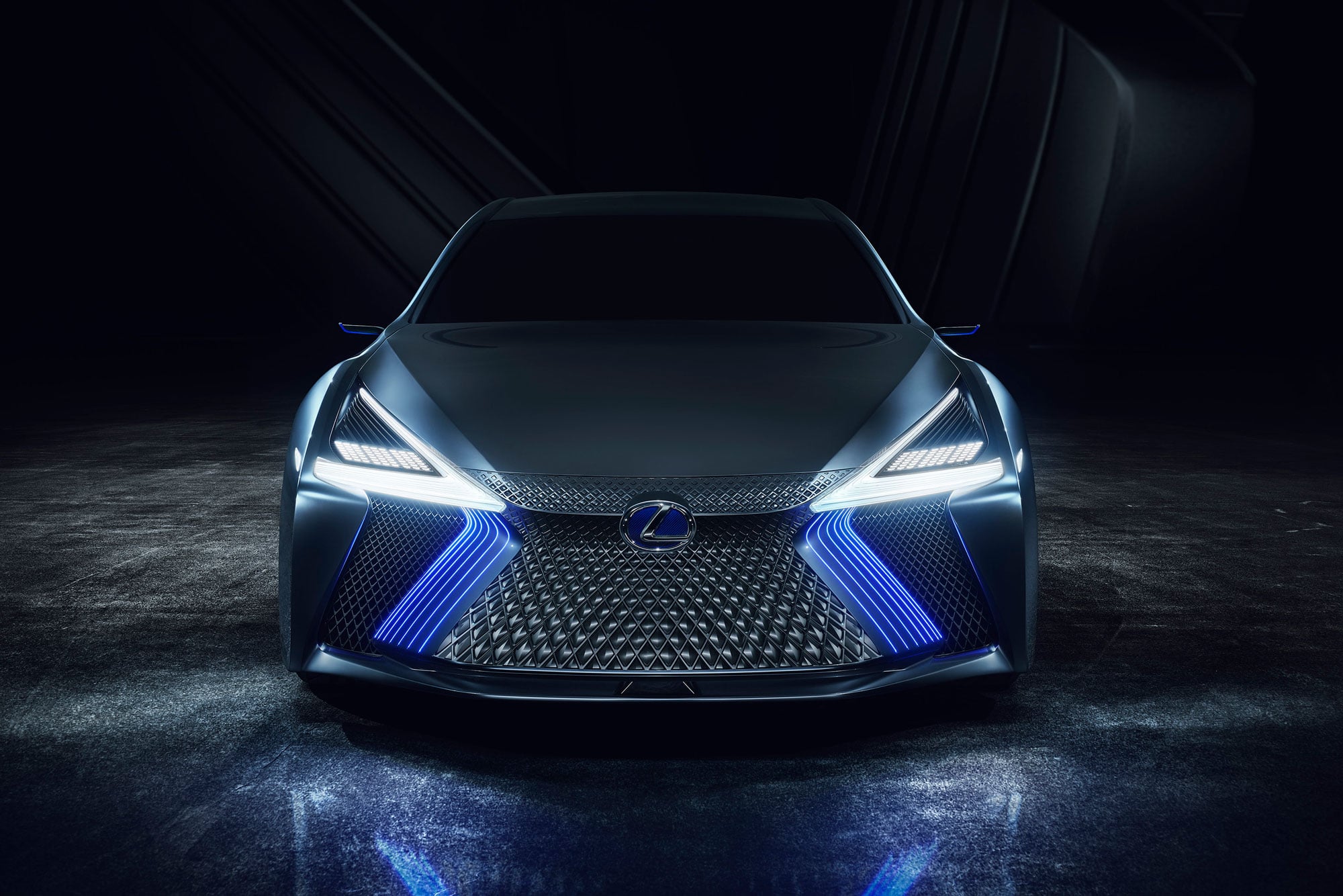 Front view of the Lexus LS+ concept vehicle with blue and white lights on, studio setting