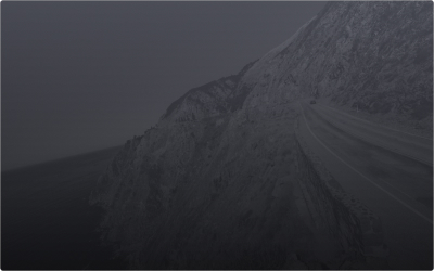 A Lexus driving along a mountain landscape with a winding path.