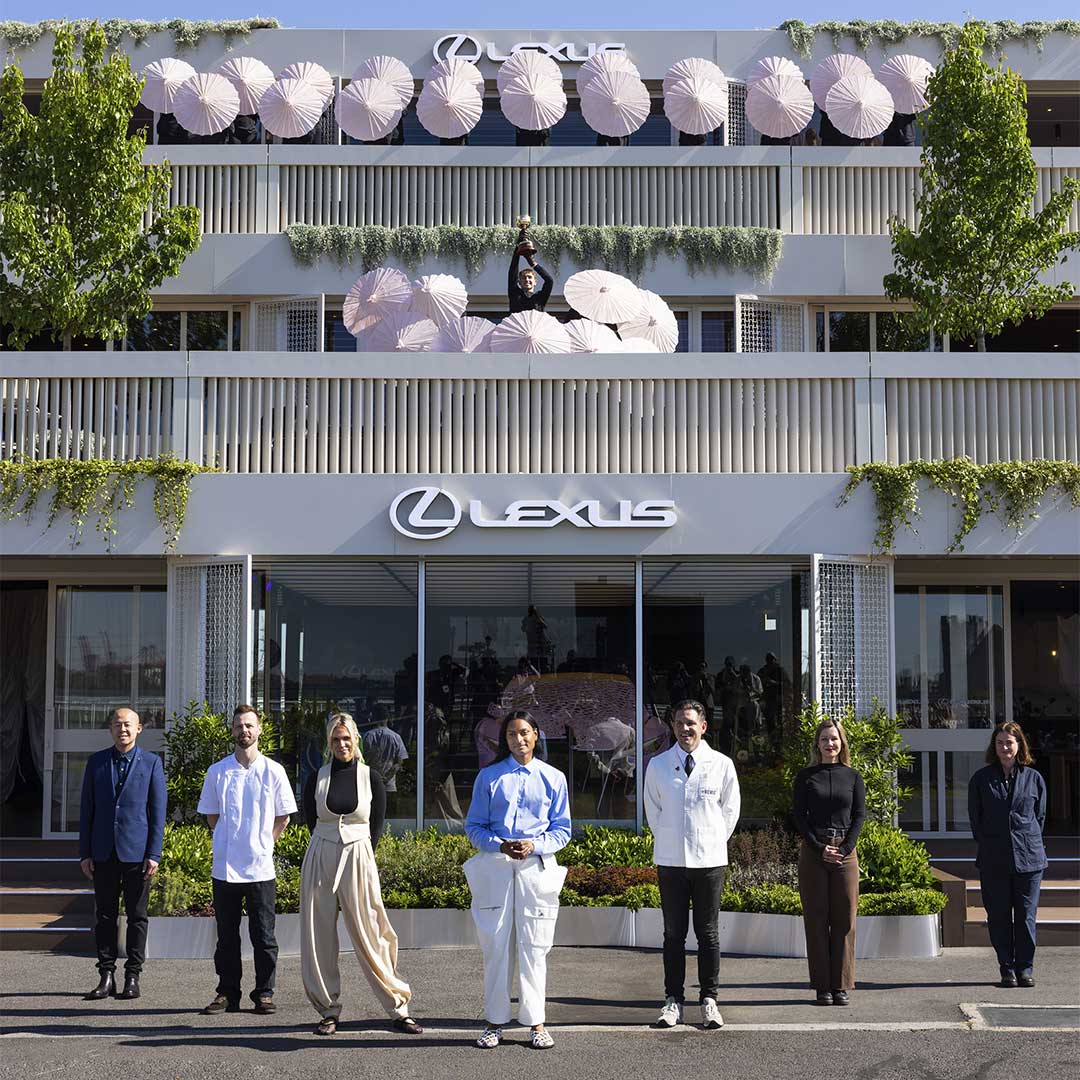 LANDMARK by Lexus Pavilion at the Melbourne Cup Carnival with staff and a performer holding Melbourne Cup trophy