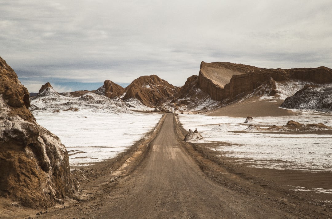Scenic dirt road with mountains and snow