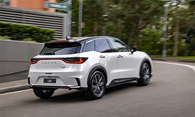 White Lexus LBX driving along a road