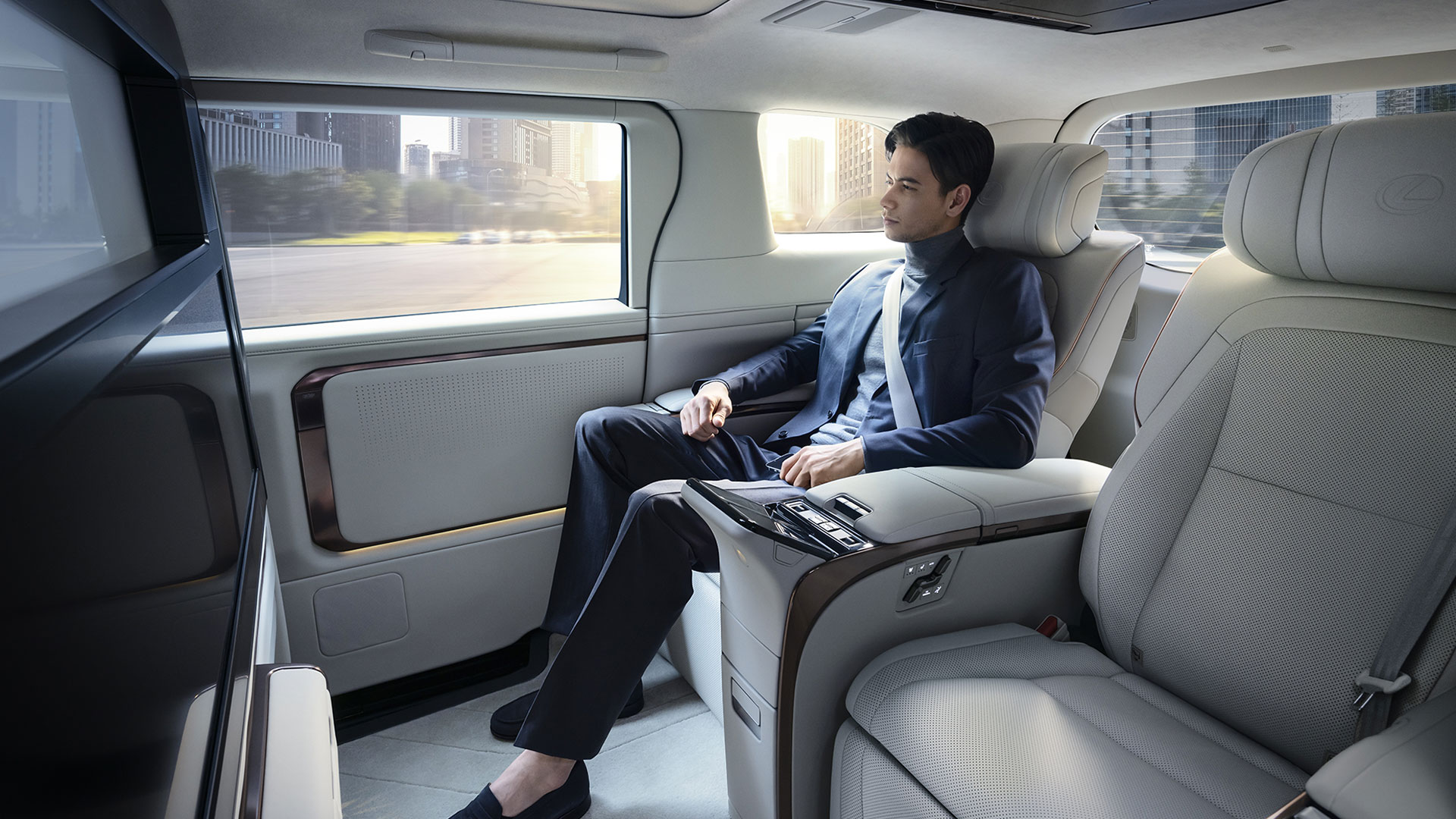  Lexus LM interior with a man sitting comfortably in the luxurious back passenger area.
