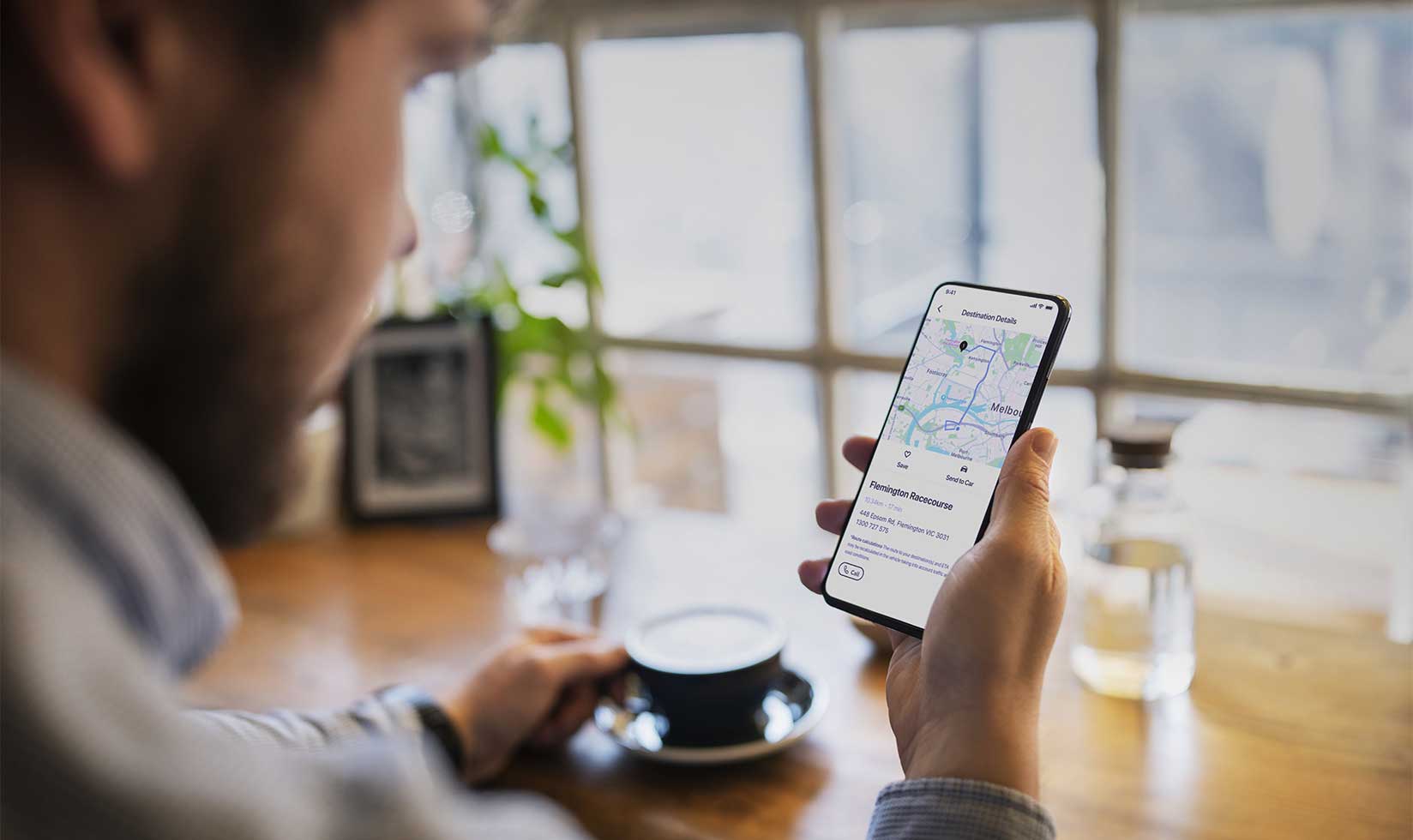 Man looking at connected navigation on phone