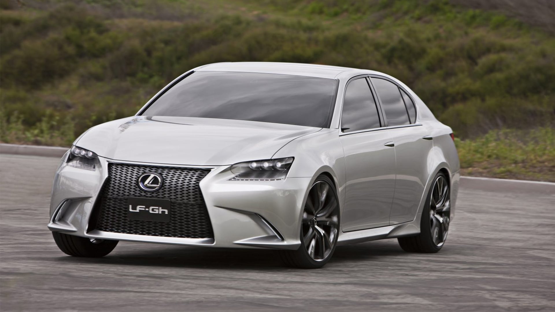 A silver LF-Gh concept car parked against a green background