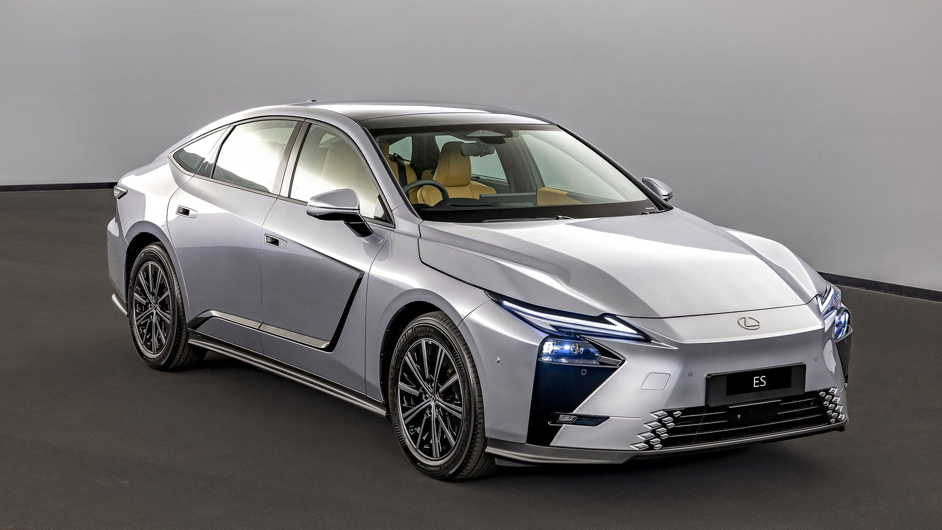 The Lexus ES luxury sedan in silver in a studio setting